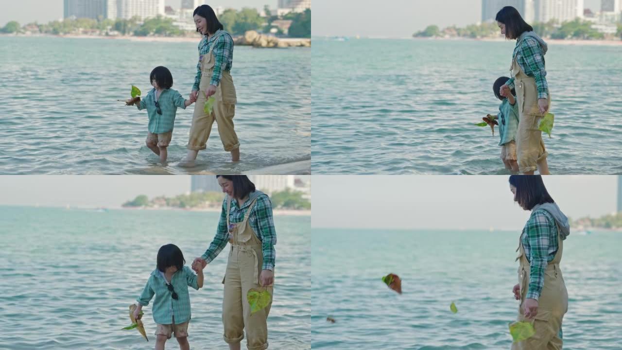 亚洲家庭在海滩上共度时光。
