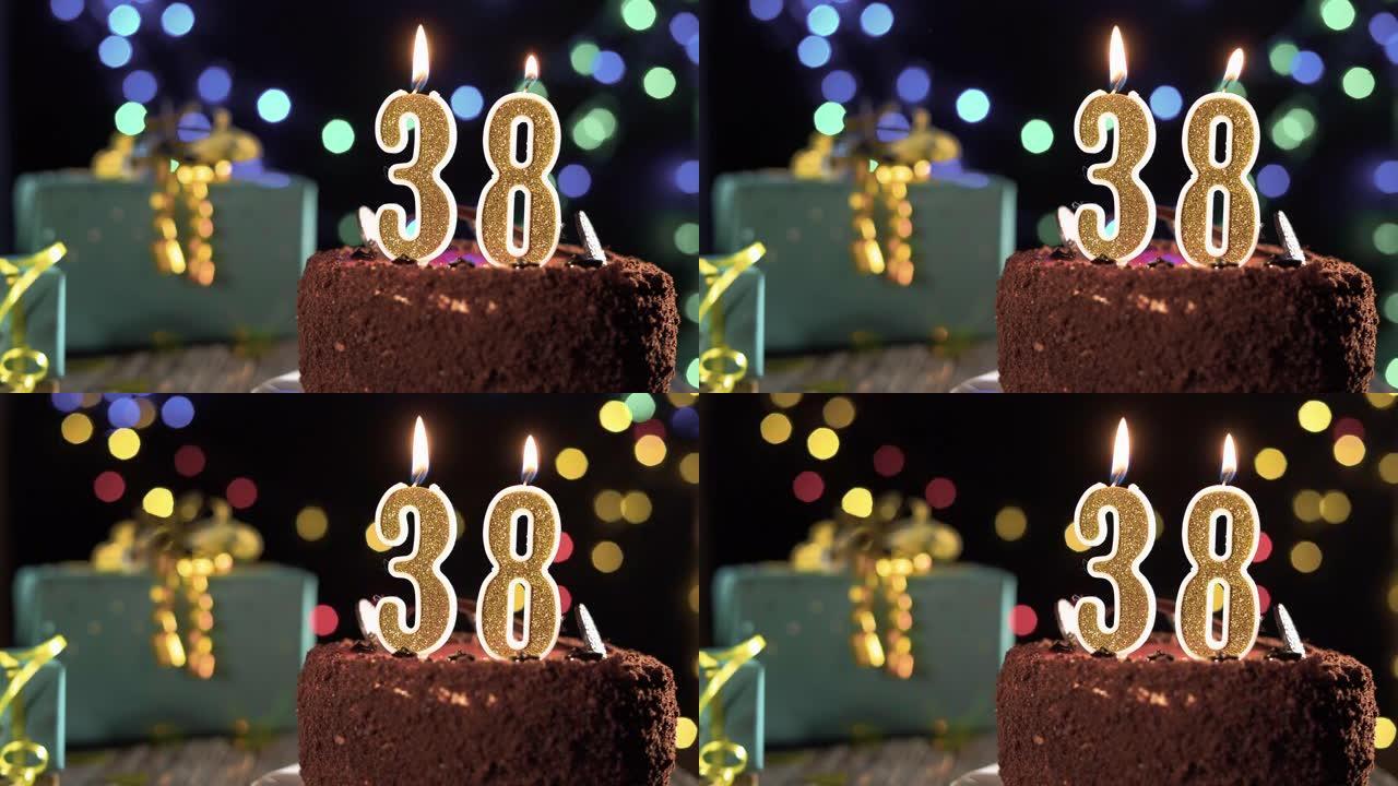 38岁生日的生日蜡烛放在桌子上的甜蛋糕上。打火机上的火，吹灭节日蜡烛。