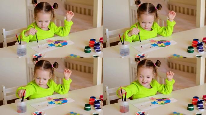 小女孩用水彩和水粉在纸上画了一颗心。