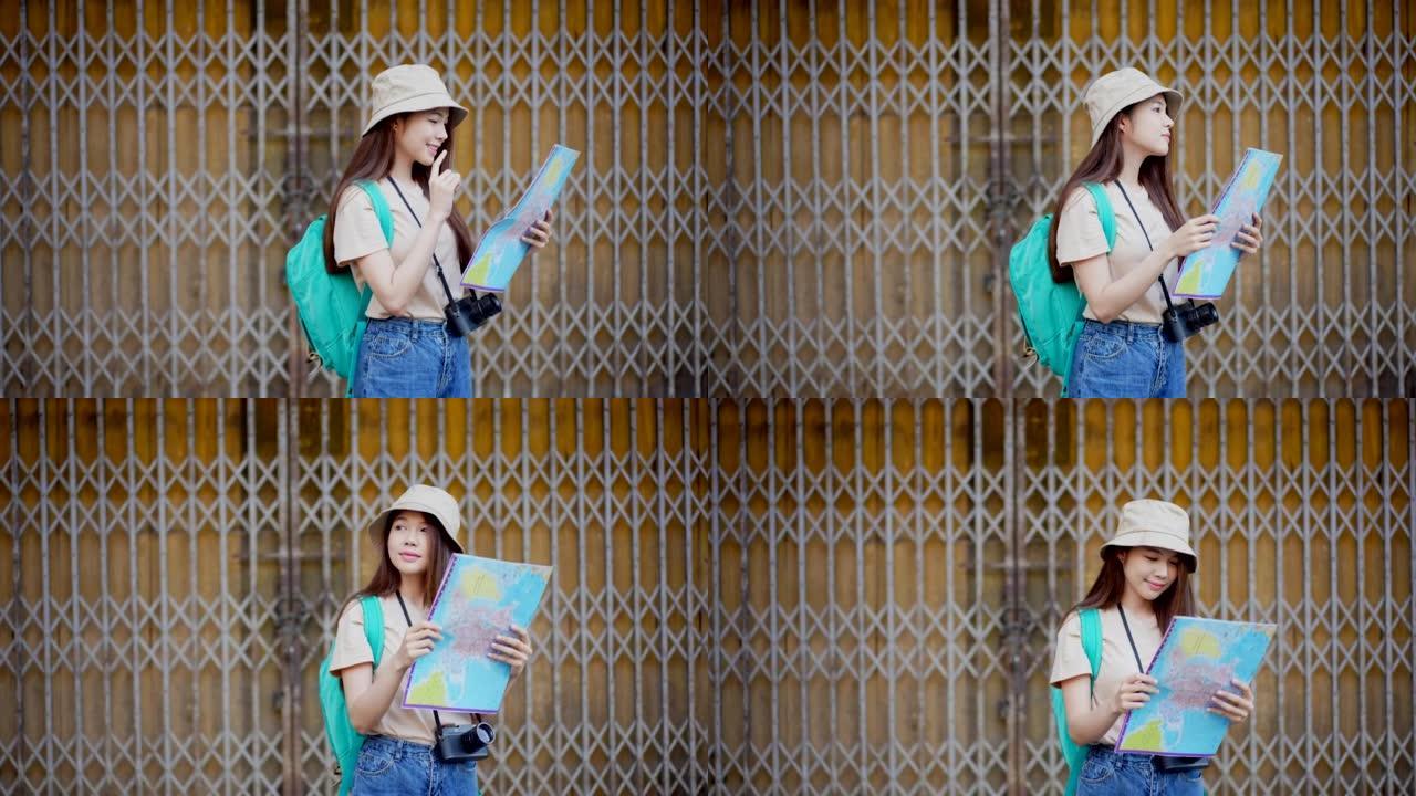 无标题项目漂亮的亚洲女性游客，背包在观光和探索时看着地图
