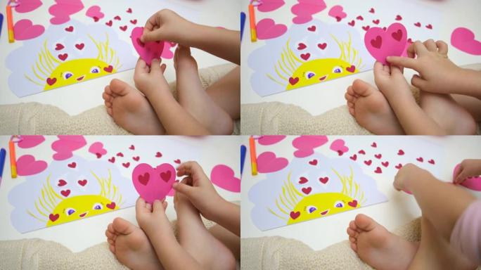 儿童玩胶带纸，用太阳和心制作有趣的卡片