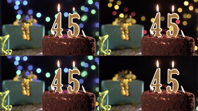 45岁生日，桌子上的甜蛋糕上的45岁生日蜡烛。打火机上的火，吹灭节日蜡烛。