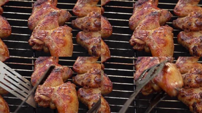 在烤架上旋转的木串上开胃的鸡翅特写