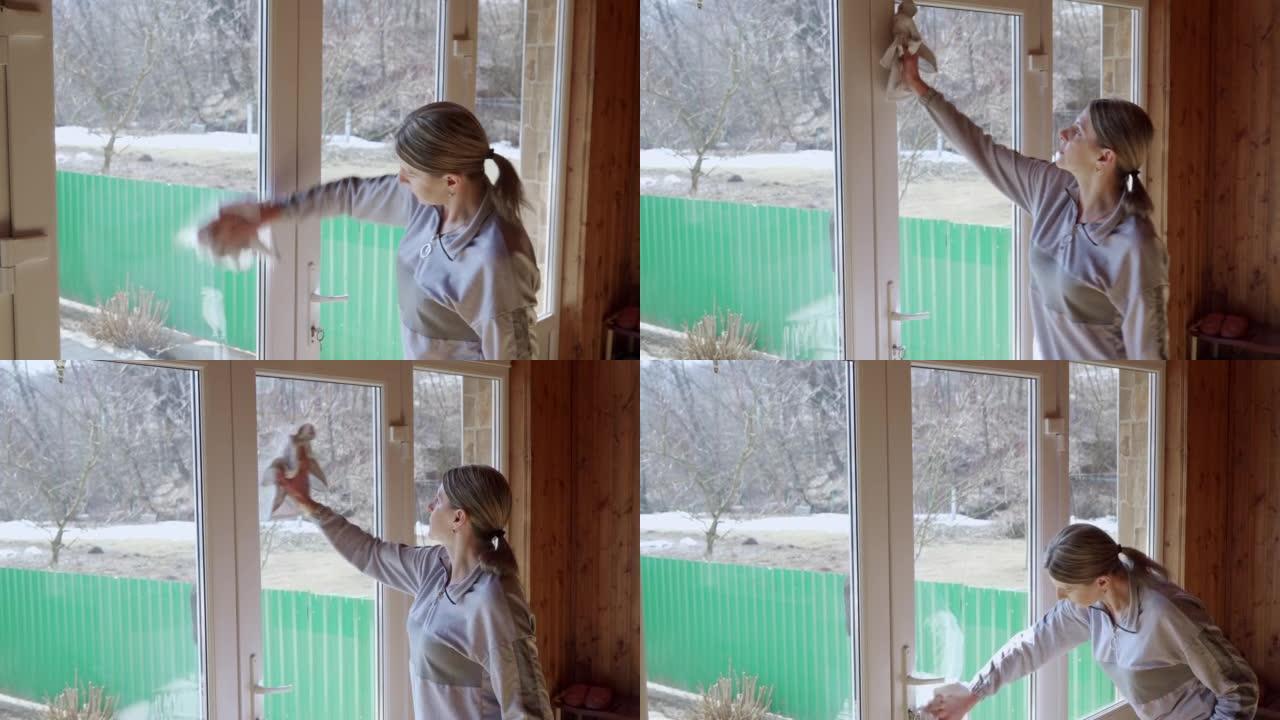 一个女人正在打扫房子，她洗窗户。