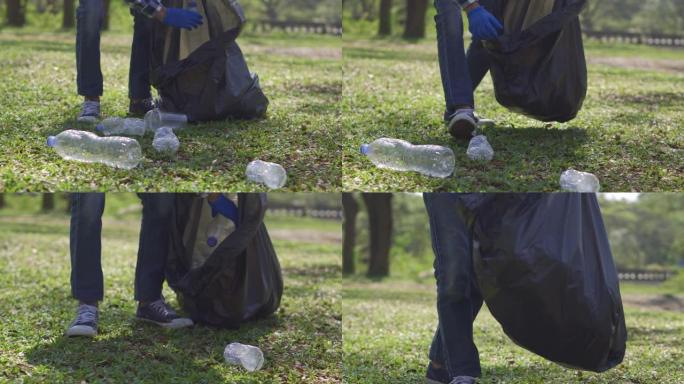 志愿者在社会公园清洁森林安全生态概念。关闭计划。志愿者手从公园草地上捡起塑料瓶。停止塑料。民事责任。