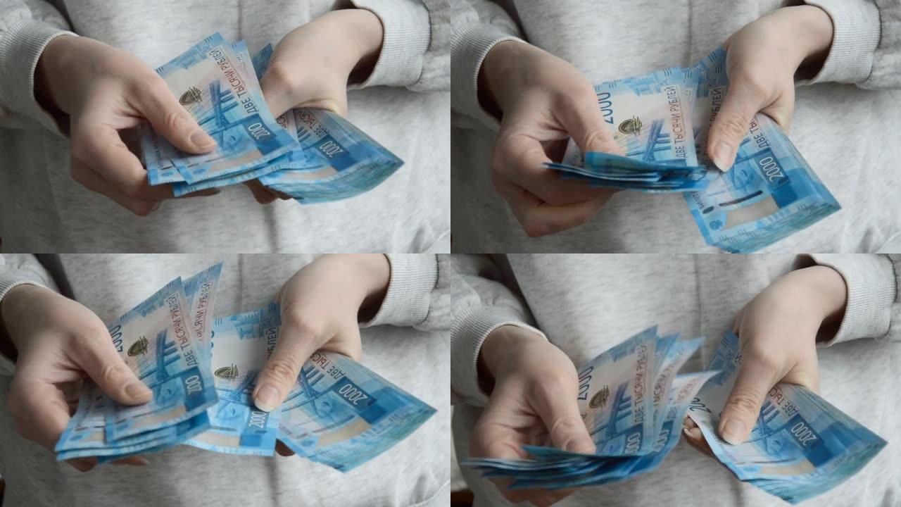 一个女人用手数钞。俄罗斯的钱，卢布。
