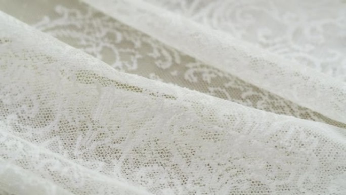 白色蕾丝特写。缝制婚纱。轻guipure。手工剪裁，专业服装理念。摘要背景