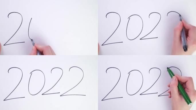 平铺改变新年。旧的一年过去了，重写了新的开始。2022结束了，写它开始2023年。在纸上划掉，用刷子