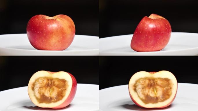 半个盘子里的苹果，里面烂了，果核烂了但从外面看很好吃，4k镜头。