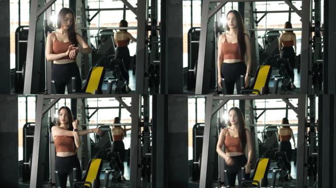 一名亚洲女子在健身房，正在热身，为健身做准备