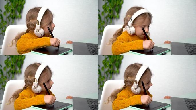 一个小女孩用图形平板电脑在线学习，一个戴着耳机的孩子在笔记本电脑上学习图形设计