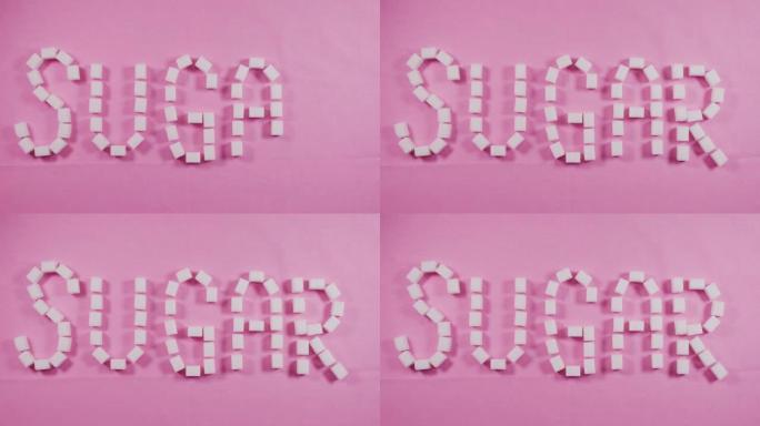 戴着蓝色手套的人在粉红色的背景上展示了精制糖的糖块一词。龋齿的概念