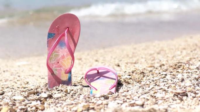 沙滩上的粉色人字拖