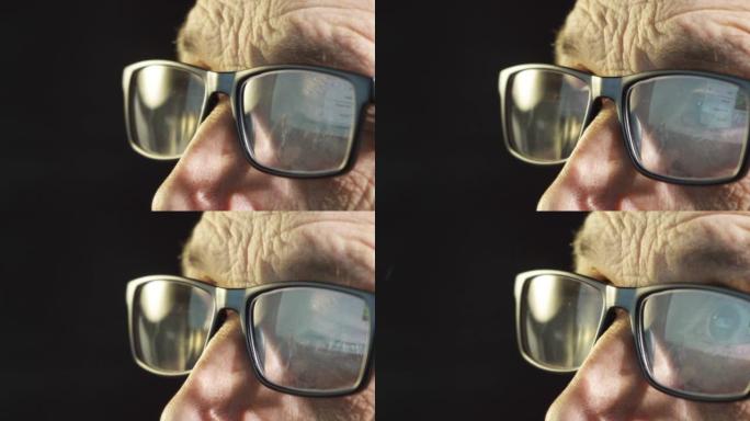 一位戴着电脑眼镜的商人聚焦眼睛的特写