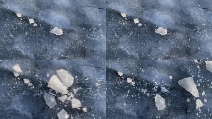 薄冰上的危险。俯视图中的冰碎片-风景格式。背景的冰面; 冰冻的水面。