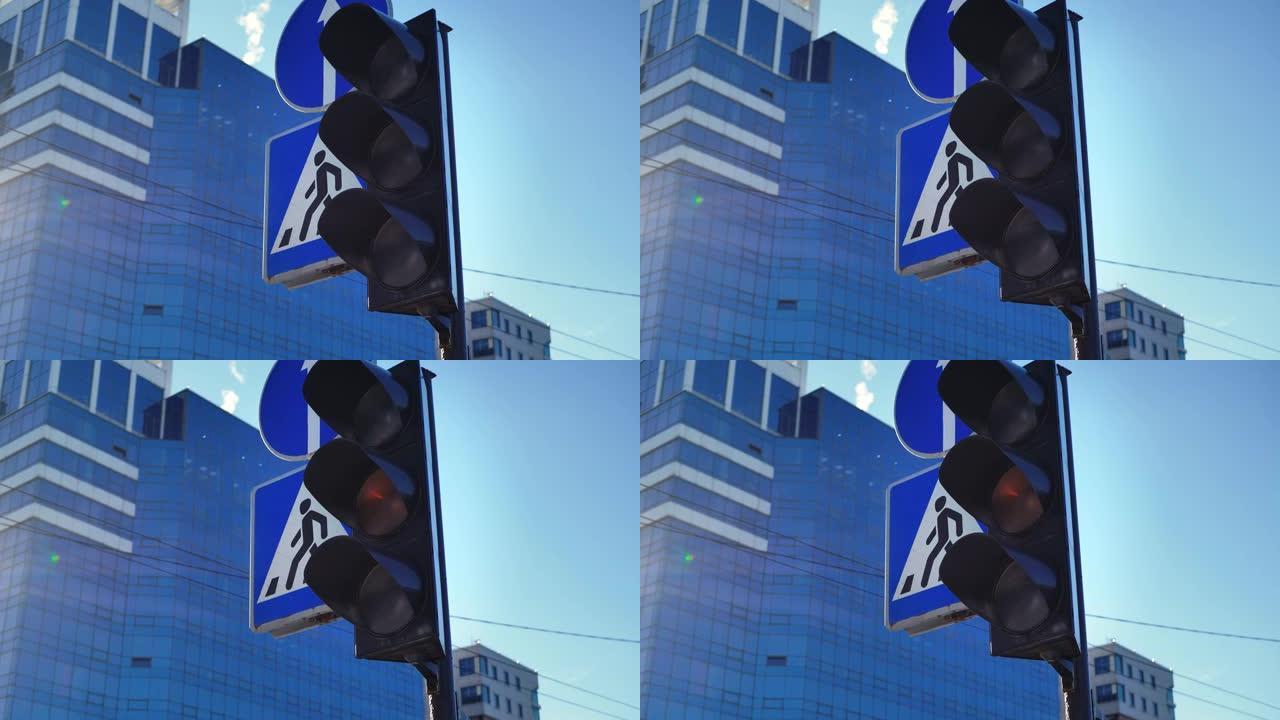 交通灯在城市十字路口切换颜色。行人过路标志