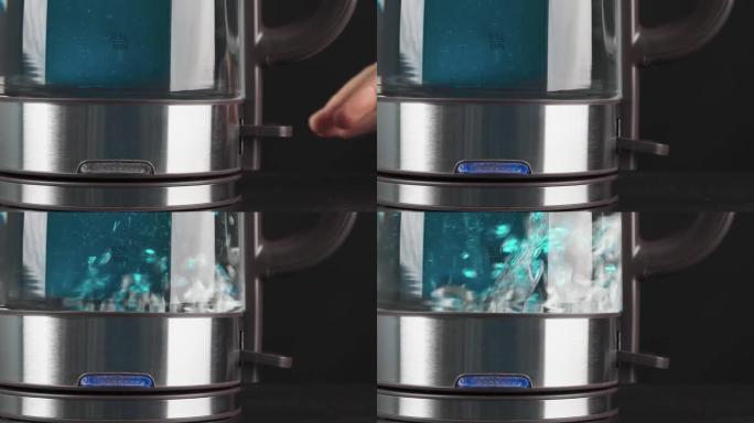 一个人的手指按下玻璃水壶的按钮烧开水。气泡在蓝光中上升。低运动。