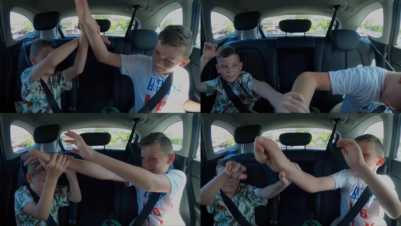 两个小子慢动作在汽车后座上打架。抬起手臂和双手，斜视和退缩。