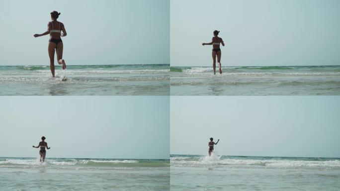 穿比基尼的女孩海上奔跑完美身材海浪
