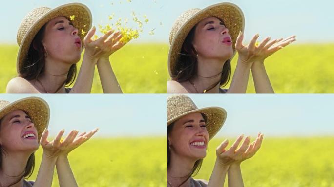 一个年轻女子在乡下吹动花瓣的4k视频片段