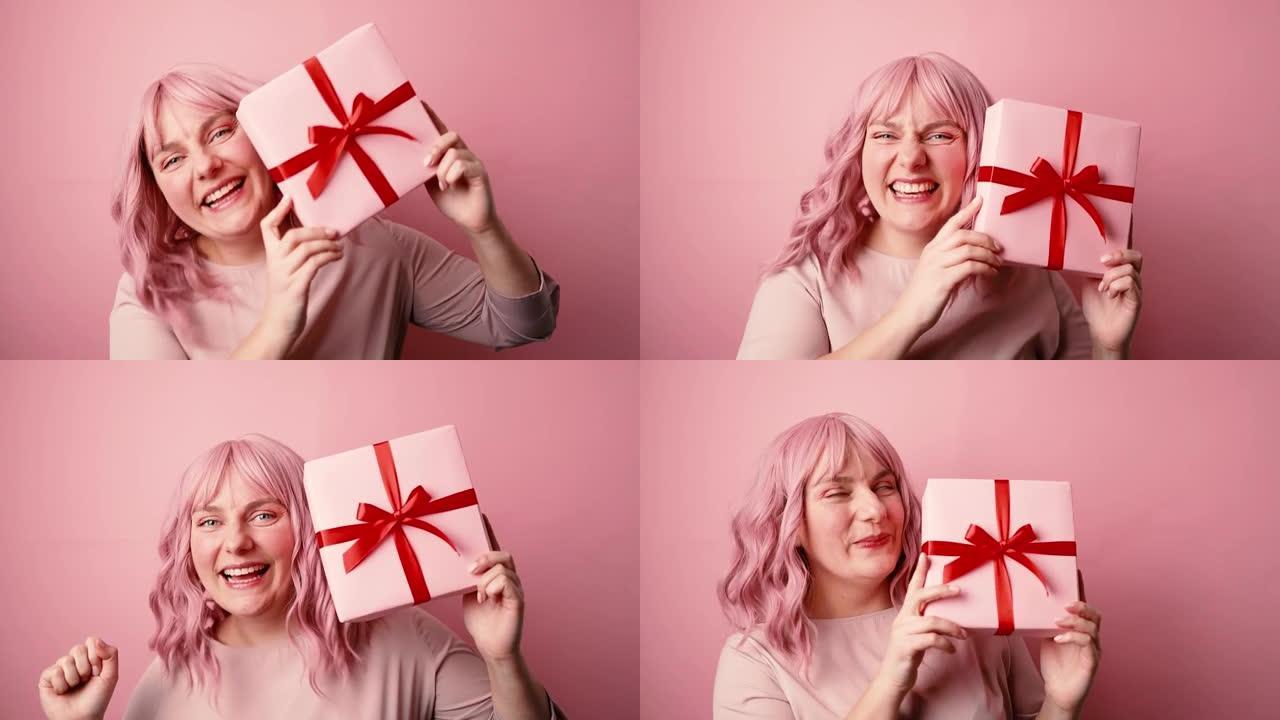 快乐的年轻粉红色头发30多岁白人妇女心情愉快拿着礼物礼盒，红色丝带蝴蝶结在粉红色背景下孤立
