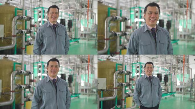 亚洲马来成熟男子工厂经理看着相机微笑