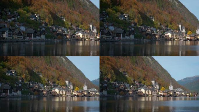 奥地利阿尔卑斯山著名旅游胜地idillyc镇Hallstatt的秋天色彩。大教堂教堂，当地房屋，高山