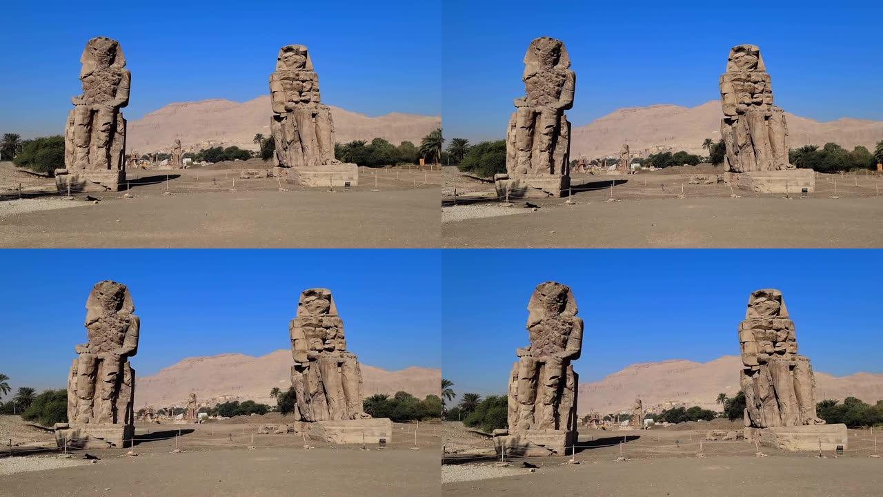 位于埃及古底比斯卢克索的卢克索神庙。梅农的巨像，法老阿蒙霍特普三世的两座石质雕像，他在第十八王朝统治