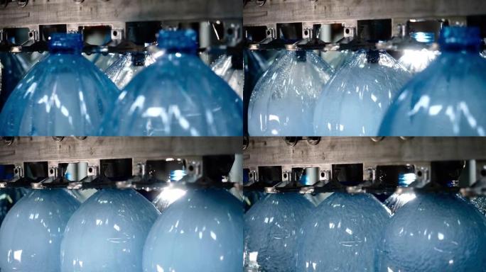 自动输送线，用于在塑料瓶中装瓶矿泉水，特写。