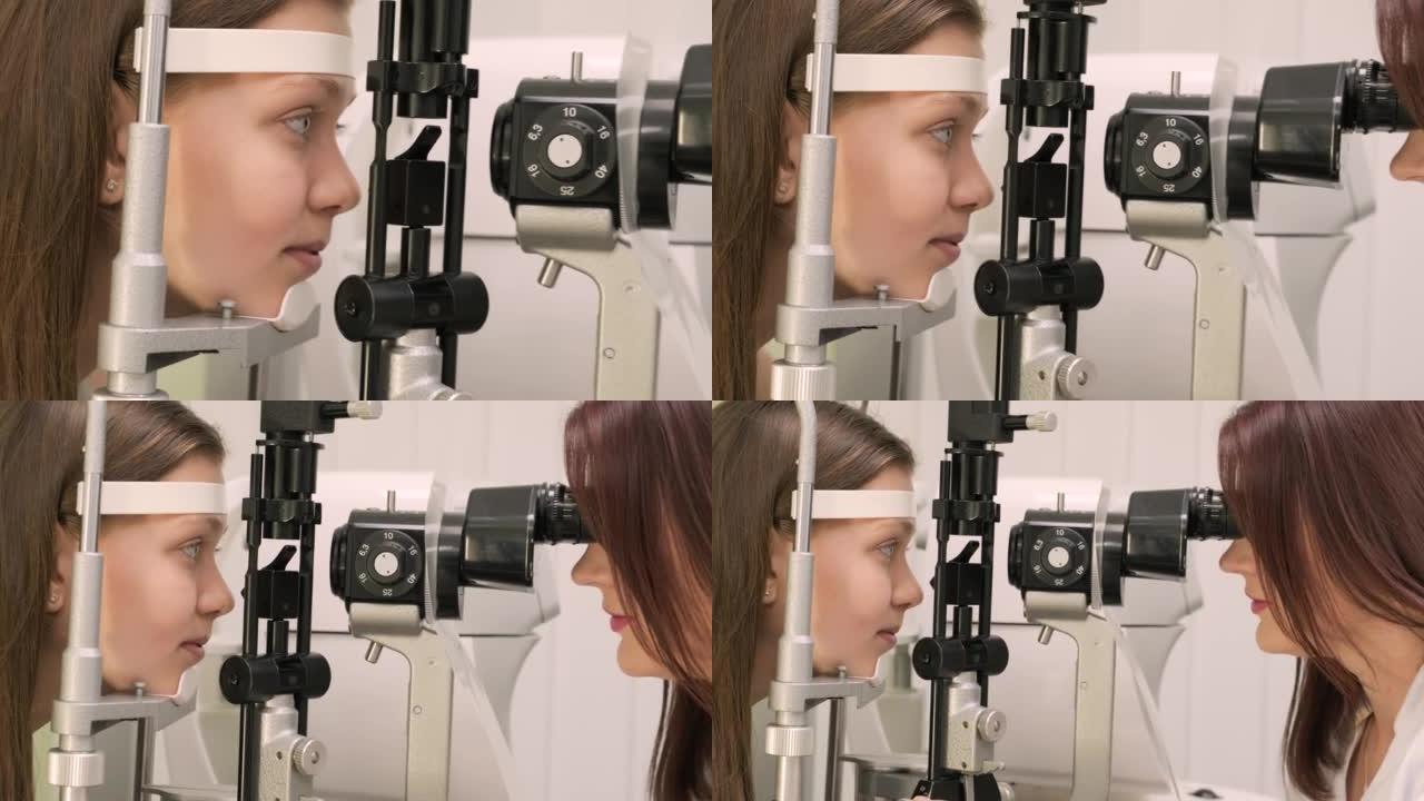 眼科医生用现代设备检查青少年的视力。医生用生物显微镜检查眼睛。在医疗设备的帮助下检查眼睛结构的女医生