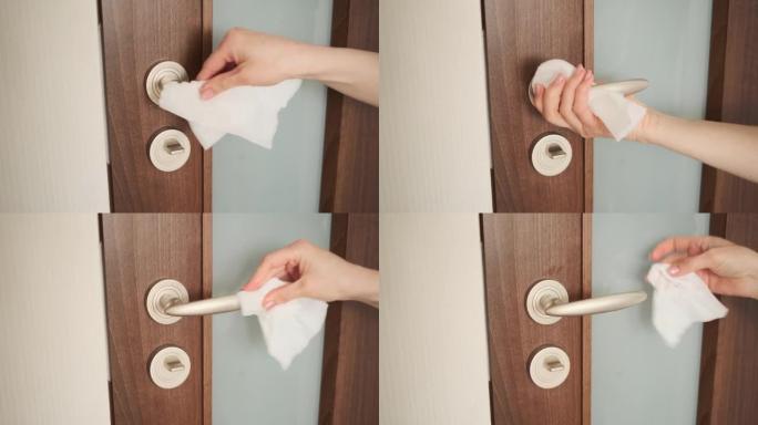 女人用纸巾清洁门把手