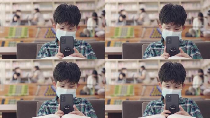 新常态，亚洲男孩脸看手机，科技教育在线