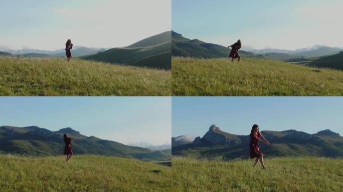 穿着红色连衣裙的年轻赤脚女子，在夕阳的蓝天下，在雾中的丘陵和山脉的背景下，在草地上跳舞。圆形全景