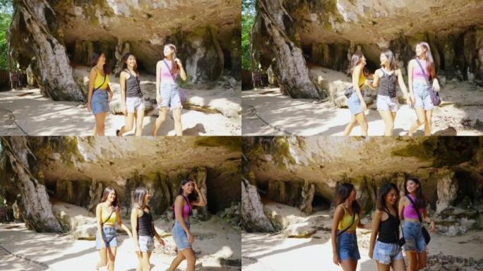 4k一群年轻的亚洲女性朋友在暑假在洞穴中旅行时一起散步