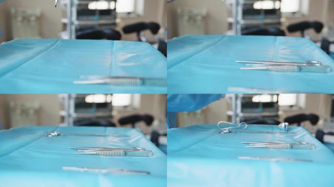 将医疗工具的桌子放在桌子上，为机器人手术做准备。手术工具。手术室盘子上的多个手术工具。医生和护士把它
