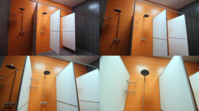 带新设备和橙色瓷砖墙的空淋浴房