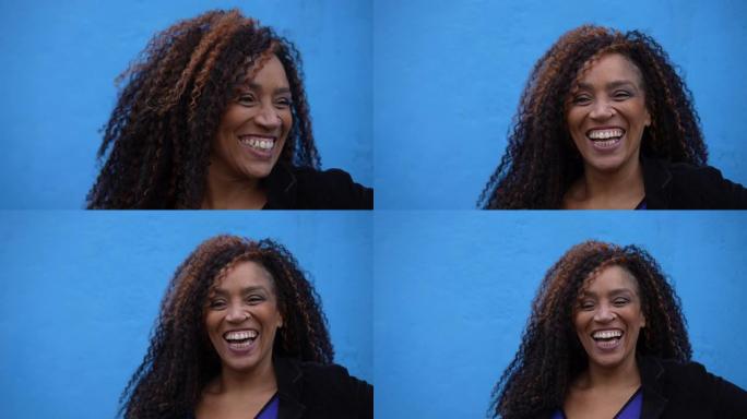 一个快乐的拉丁女人微笑的肖像脸特写蓝色背景休闲人