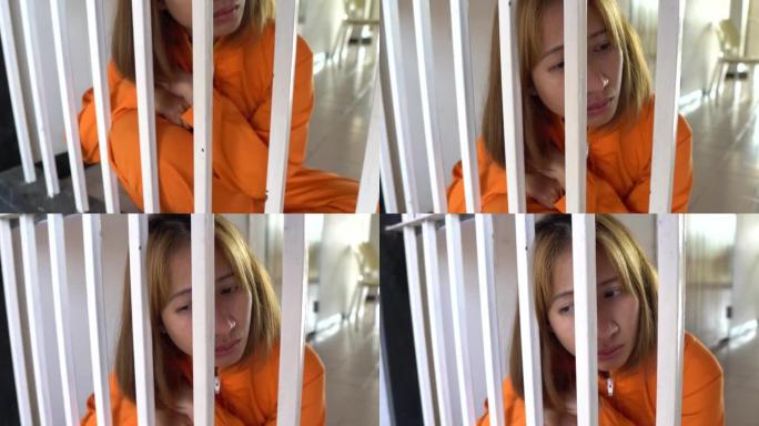 女囚犯坐在牢房里，看上去很绝望。