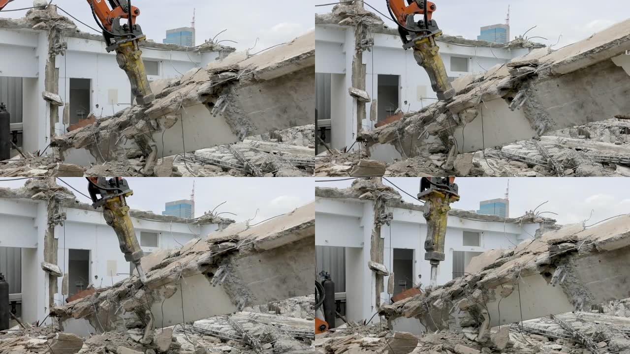 一个大的橙色Makro正在拆除的旧建筑物中挖出建筑废料。