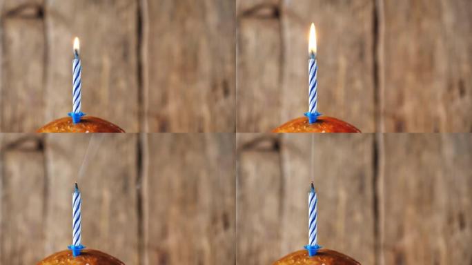 生日蛋糕庆典上的蜡烛火，木制背景
