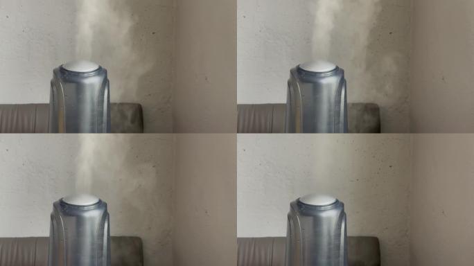 加湿器在高功率下工作，然后在灰色墙壁背景上关闭。来自加湿器的水雾蒸汽。