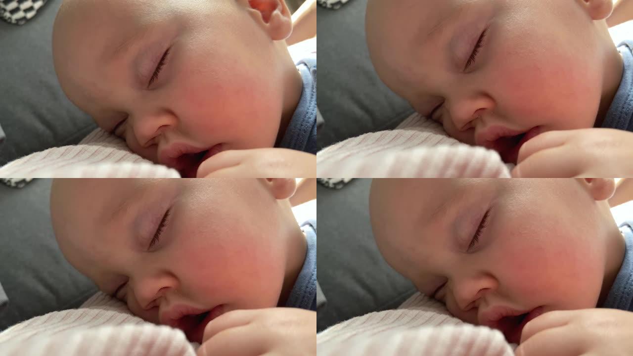 熟睡的婴儿脸部特写肖像闭着眼睛张开嘴巴粉红色的脸颊