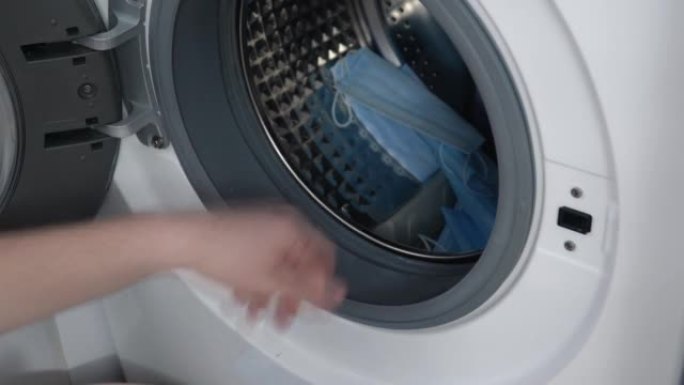 男性手用洗衣机拉出医用口罩