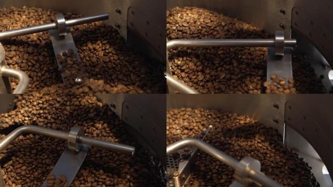 咖啡烘焙过程中的咖啡烘焙机。烤纺纱冷却器专业机器和棕色咖啡豆机芯在工厂关闭。咖啡馆的餐饮背景。慢动作