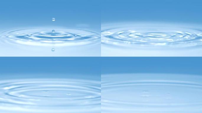 化妆品蓝色背景上清水中的抽象概念宏观慢动作水滴