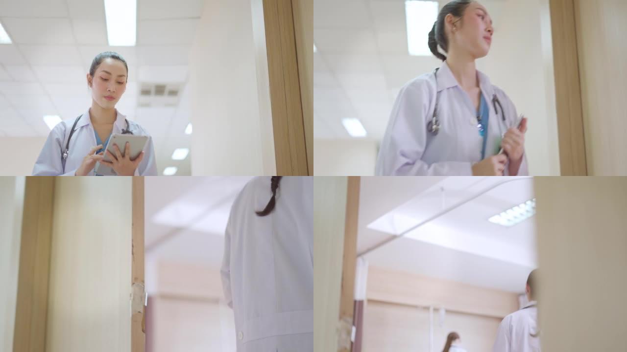专业的亚洲女性医生在医疗礼服和听诊器，通过平板电脑检查患者的状况，并在康复室行走以检查患者的症状。概