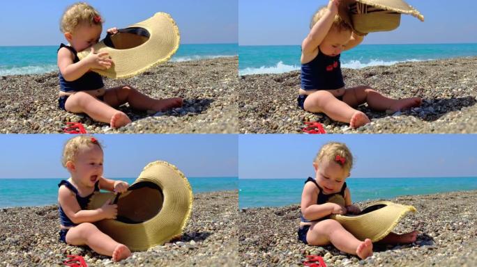 海滩上戴着帽子的婴儿。选择性聚焦。海。