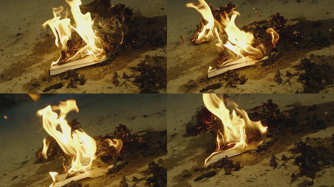 火焰点燃并燃烧。烧纸。燃烧着热篝火。飞舞的火焰火花。在慢动作的ARRI ALEXA电影摄像机上拍摄的