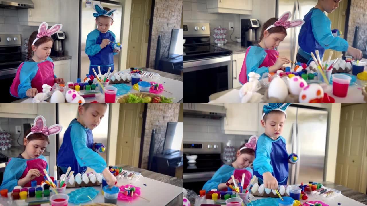 孩子们在家里的厨房里装饰复活节彩蛋