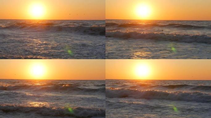 海边的日出或非常美丽的日落。沙滩和在沙滩上拍打的海浪。泡沫大风暴波
